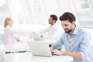 Fototapeta premium Handsome businessman working in his office