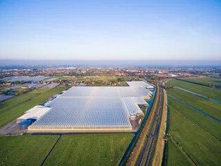 Foto op Plexiglas Aerial view of greenhouse in fields Netherlands © alexkazachok