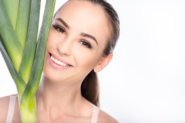Pretty girl holding green vegetable