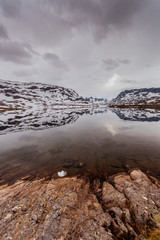 Norway scenic mountains with frozen lake.