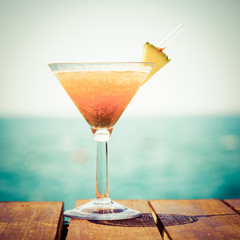 Concept of tropical vacation. Exotic cocktail on the pier. Luxur