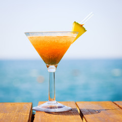 Concept of tropical vacation. Exotic cocktail on the pier. Luxur