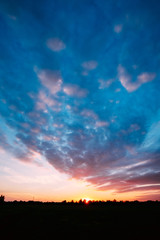 Sunset, Sunrise Over Rural Field Meadow. Bright Dramatic Sky