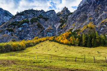 Obraz premium Alps autumn colorful mountain landscape with blue cloudy sky. Austria, Tyrol.