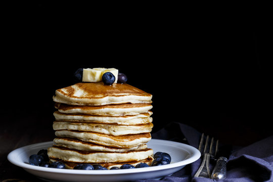 Pancakes served with Blueberries and Maple Syrup