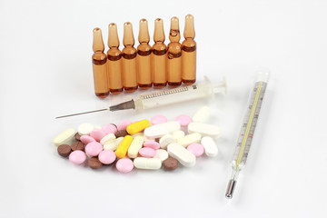 medicinal tablets, ampules for injections, thermometer, syringe