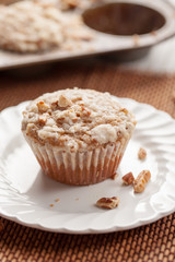 Walnut crumb sweet potato muffins in an old tin and on an antique plate