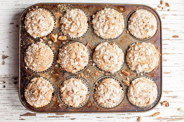 Walnut crumb sweet potato muffins in an old tin top view