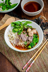 asian noodle soup with beef meatball with fresh vegetable on woo