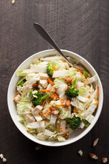 Asian Napa cabbage salad with organic broccoli, almonds, chicken, and a rice vinaigrette top view with room for text