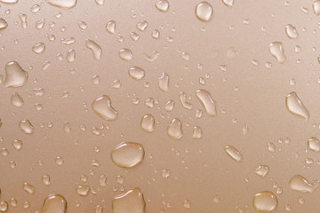 Fototapeta na wymiar Drops of water on gold metal texture