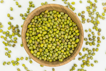 Mung beans in wood bowl isolated on white background