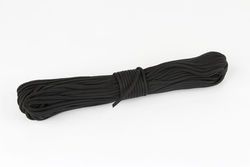 coil of dark rope paracord on a white background