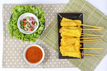 Charcoal boiled pork satay on butcher served , home made in big size, served with Thai cucumber chili sauce ( Ar Jad in Thai) and nut sauce are popular Asia cuisine.
