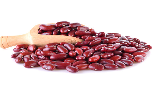 Red beans in a wooden spoon, isolated on white