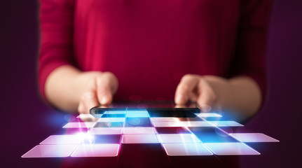 Naklejka premium Close up of hand holding tablet with cyber application