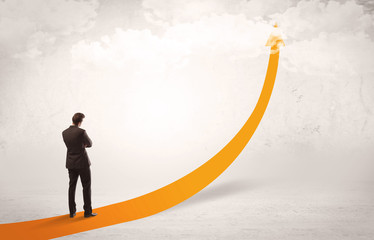 Business person standing on orange arrow