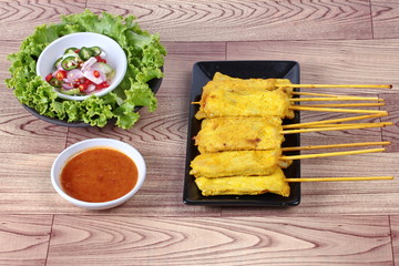 Charcoal boiled pork satay on butcher served , home made in big size, served with Thai cucumber chili sauce ( Ar Jad in Thai) and nut sauce are popular Asia cuisine.

