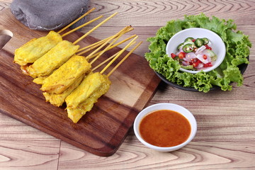 Charcoal boiled pork satay on butcher served , home made in big size, served with Thai cucumber chili sauce ( Ar Jad in Thai) and nut sauce are popular Asia cuisine.
