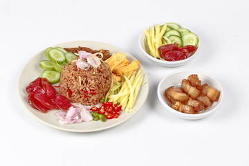 Thai food ,Fried jasmine rice with shrimp paste,(Kao Klok Kapi) with green mango roll,Chinese sausage,crispy dried fish,shrimp,chili,shallots,stir sweet pork,cucumber and scrambled egg .
