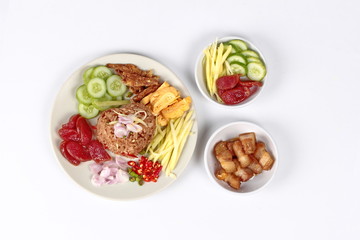 Thai food ,Fried jasmine rice with shrimp paste,(Kao Klok Kapi) with green mango roll,Chinese sausage,crispy dried fish,shrimp,chili,shallots,stir sweet pork,cucumber and scrambled egg .