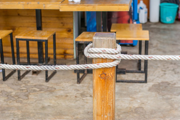 closeup of rope at the wooden stilts.