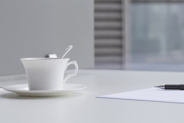 Business concept , blank paper and cup of fresh coffee on the table in office 