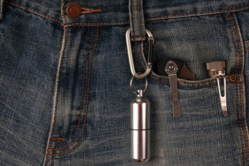 metal carabiner and tools on the jeans