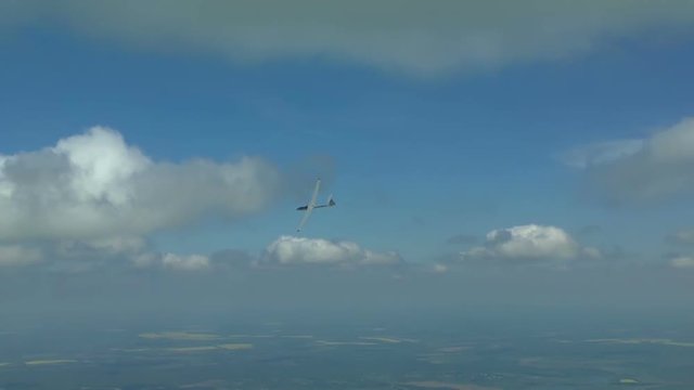 glider in the sky clouds