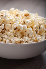 Olive oil popped popcorn in a porcelain bowl macro shot