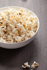 Olive oil popped popcorn in a porcelain bowl close shot