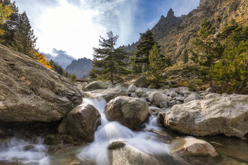 Fototapeta na wymiar Waterfalls in the mountains of Restonica valley in Corsica