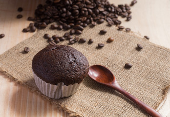 Cupcake on fabric  with coffee beans background.