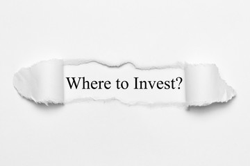 Fototapeta premium Where to Invest on white torn paper