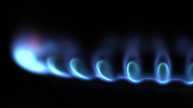 Burner gas stove close-up. Gas burns with a blue flame.