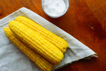 rustic concept just cooked corn with salt on table