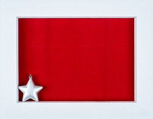 White wooden frame and a star over a red background