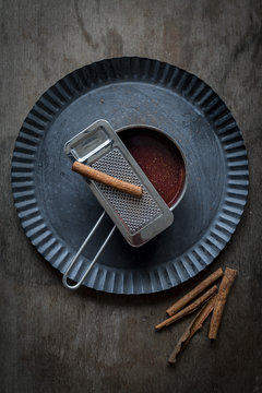 Chocolate sauce in small pot on rustic tin plate with freshly gr