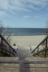 Fototapeta na wymiar walkpath to the beach made with wood and reeds