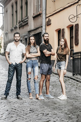 Obraz premium Four friends standing on street