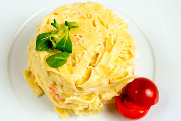 close-up of plate of pasta and smoked salmon with tomato