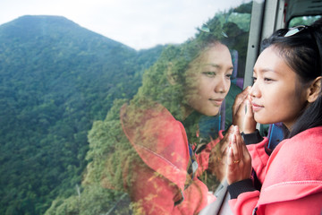 Obraz premium woman in a bus looking out the window into the valley