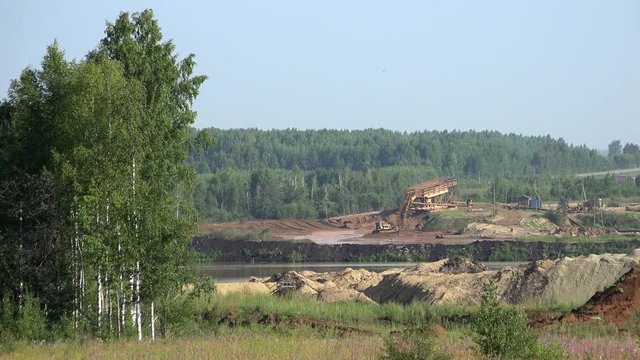 Industrial landscape. Gold mining in Ural mountains near Nevyansk. Dredge separator on river dragging gold sand