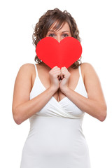 Young woman holding red paper heart