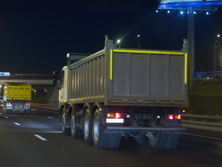 dump trucks transport freight on the night