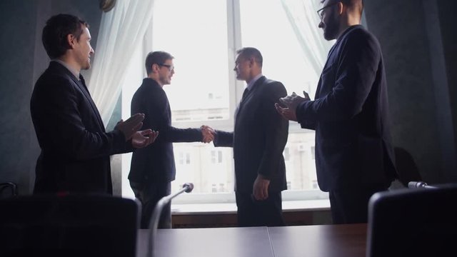 Business partners greeting each other after signing contract