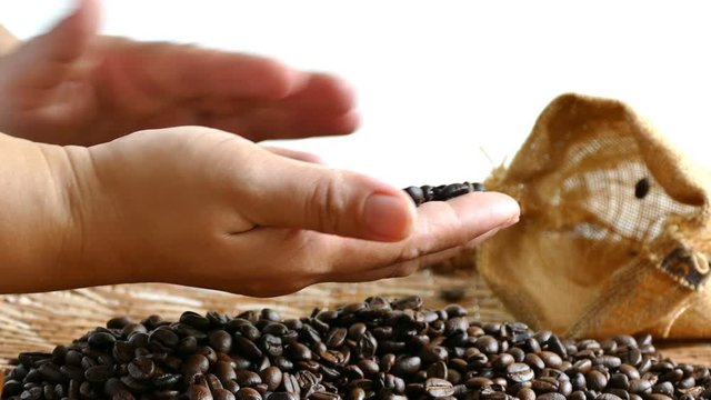 4K footage of Aromatic roasted coffee beans in hand