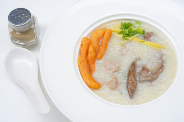 Congee with pork and ginger slices on top Rice porridge with pork 
