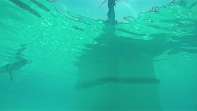 man swims view from under the water