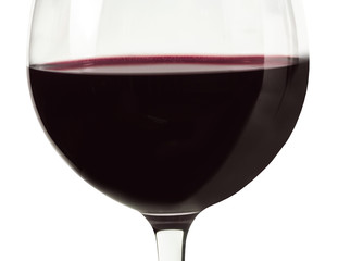 Closeup of red wine glass on white background